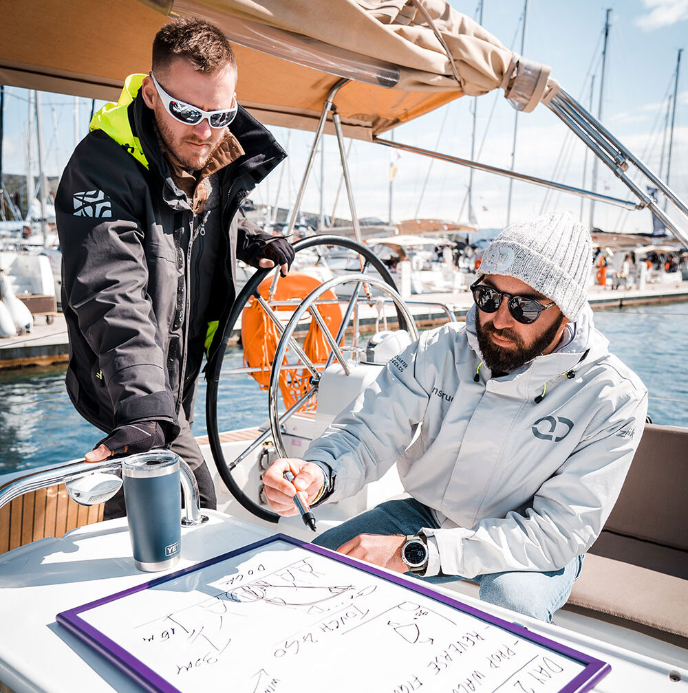 Skipper Academy instructor guiding yacht handling during training