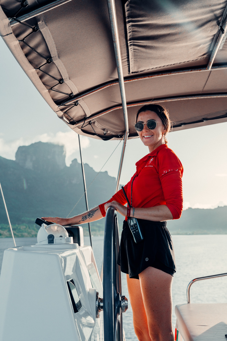 Female skipper operating a sailing yacht